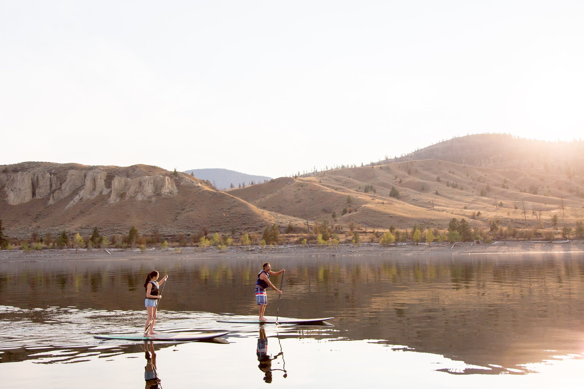 Two paddle boarders on the water in Kamloops