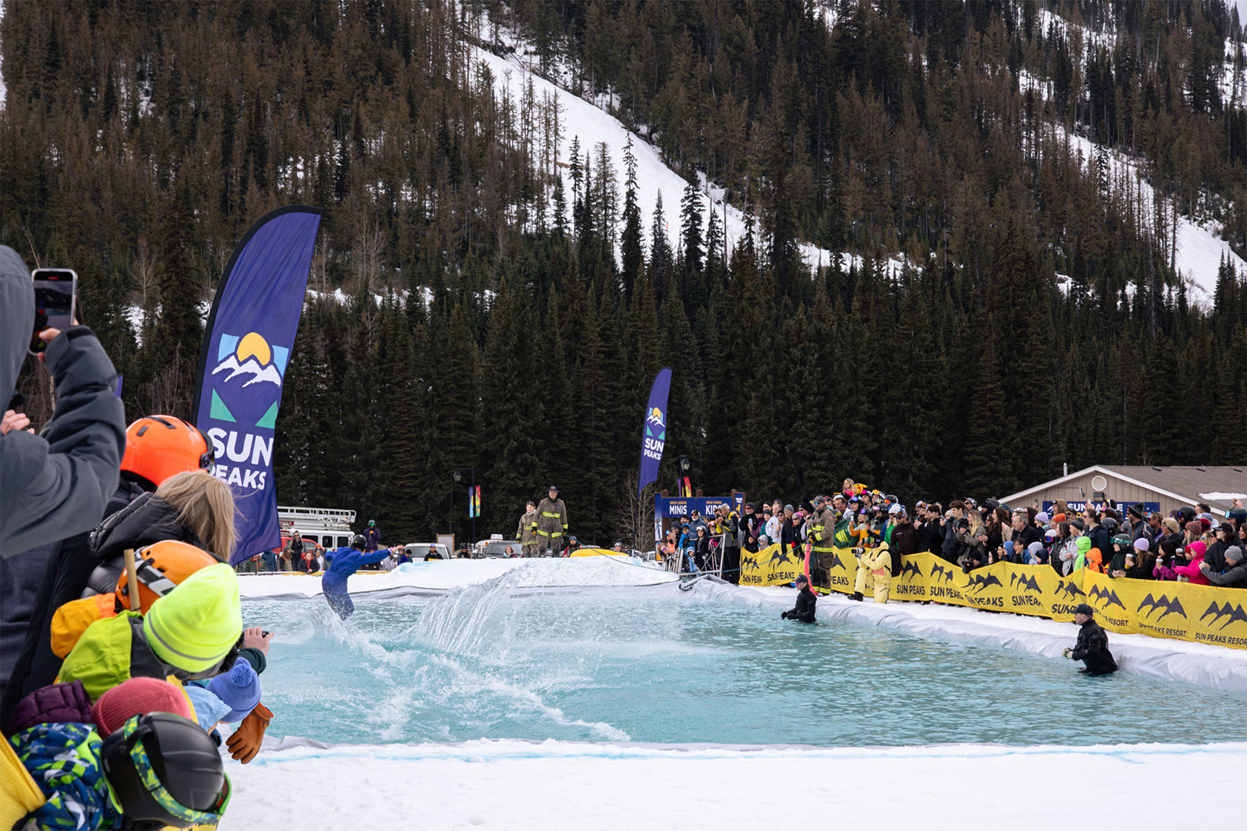 Boarder rides on a pool of water at Sun Peaks Slush cup.