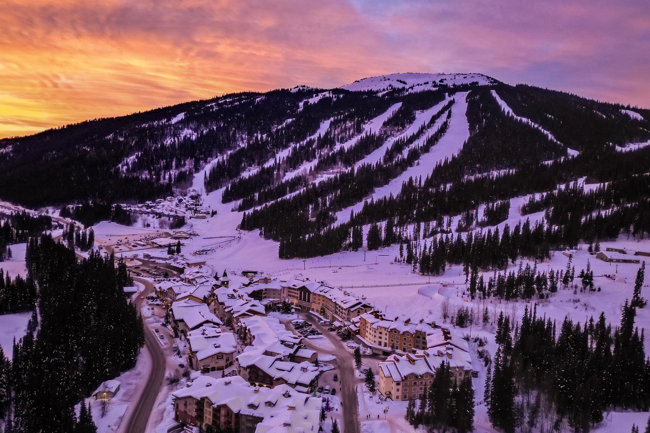 Sun Peaks Village and Tod Mountain in winter at sunset.