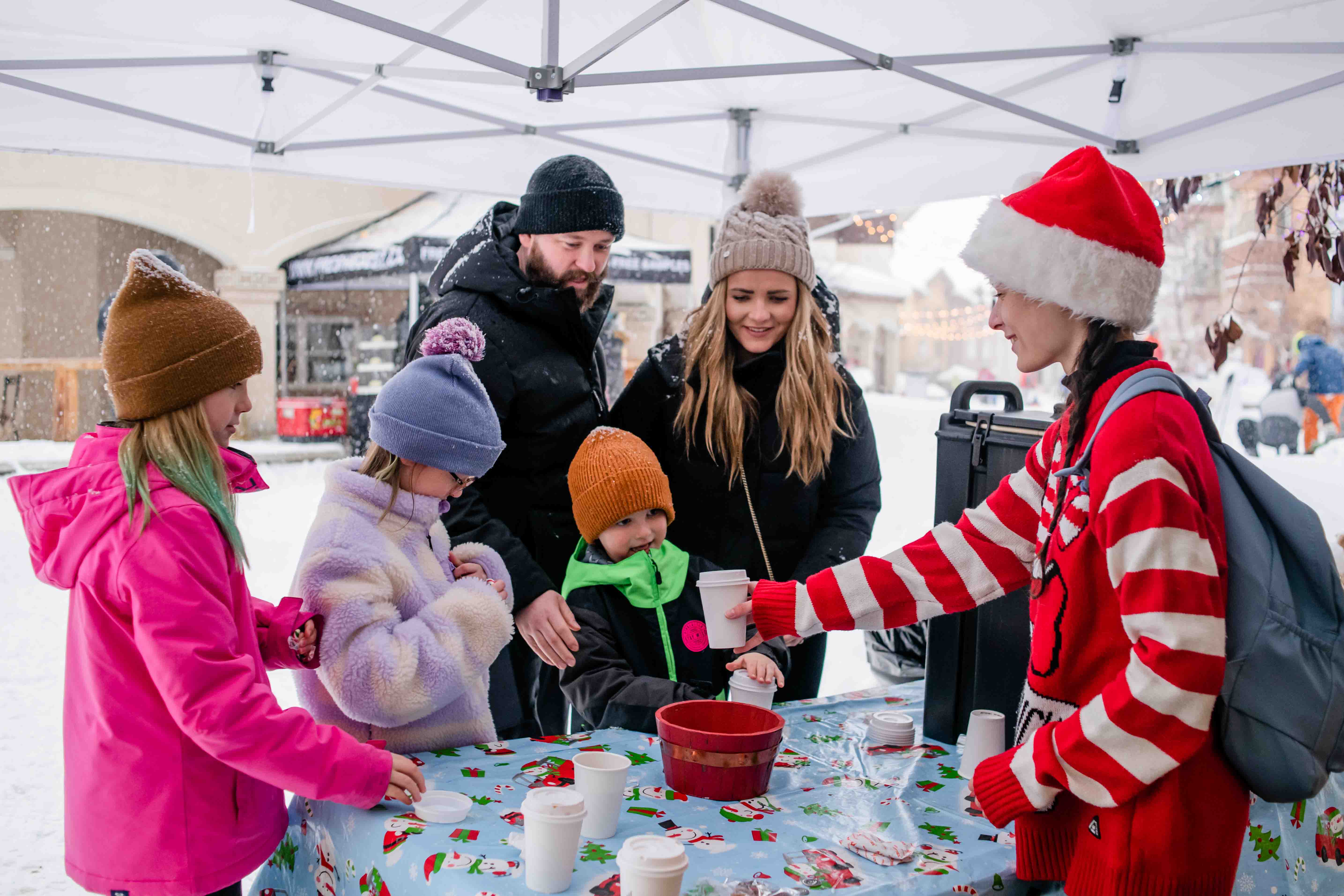 family getting hot chocolate during christmas