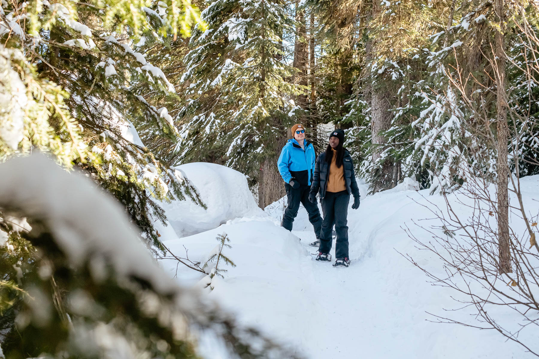 couple snowshoeing in sun peaks