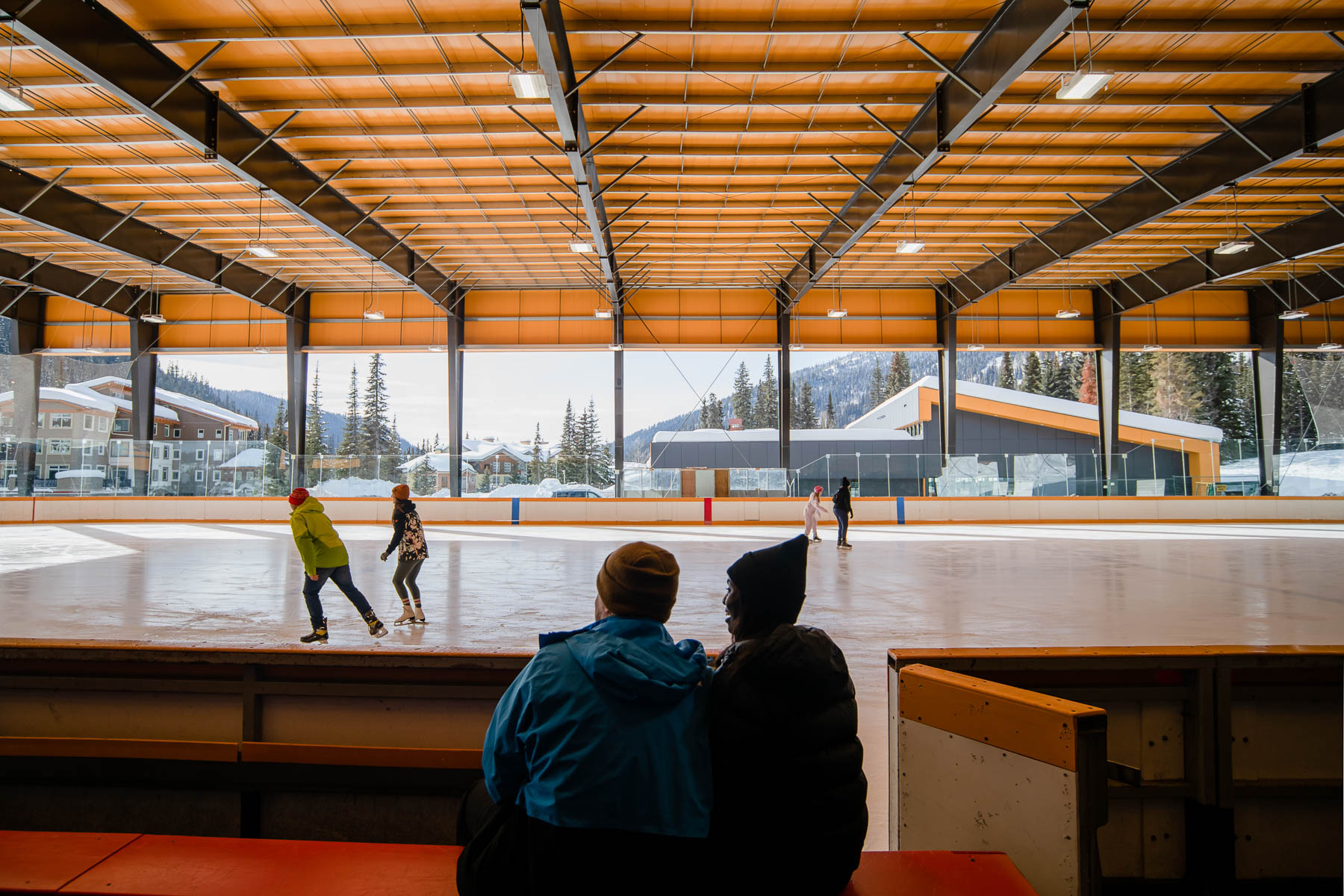 couple skating in sun peaks