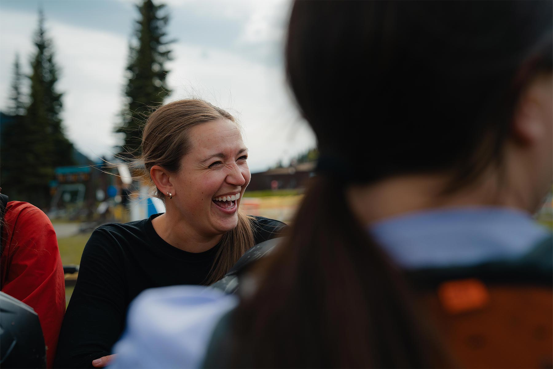 woman laughing at people beside her