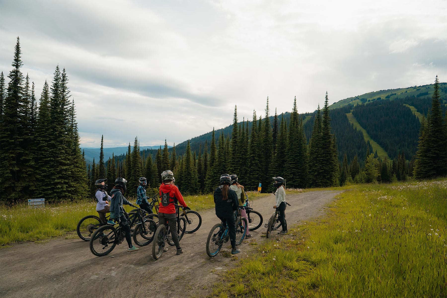 group of ladies on bikes outside with a mountain in the background