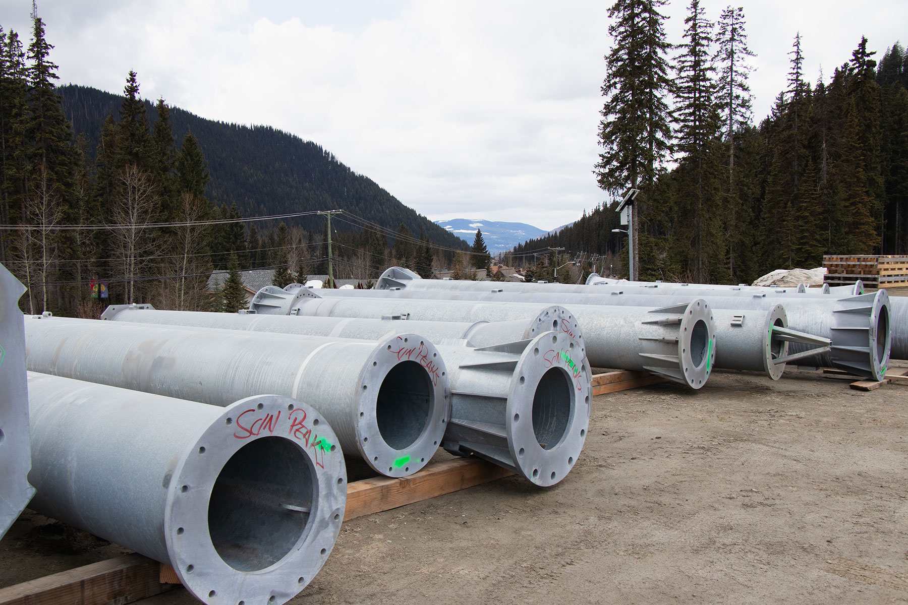 Lift towers for new West Bowl Express chairlift staged in parking lot.