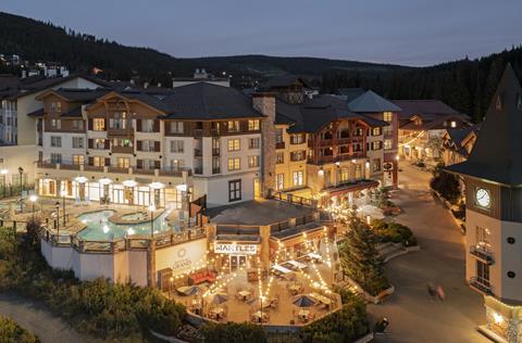 Night view of lights on a patio and pool and village stroll