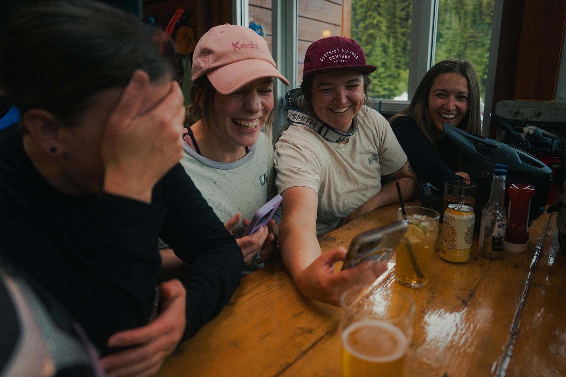 a group of girls looking at a phone laughing
